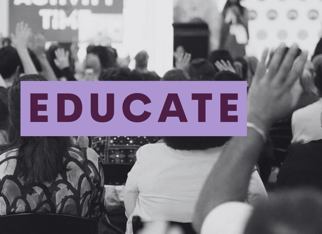 black and white photo of people at the conference with raised hands. text reads Educate