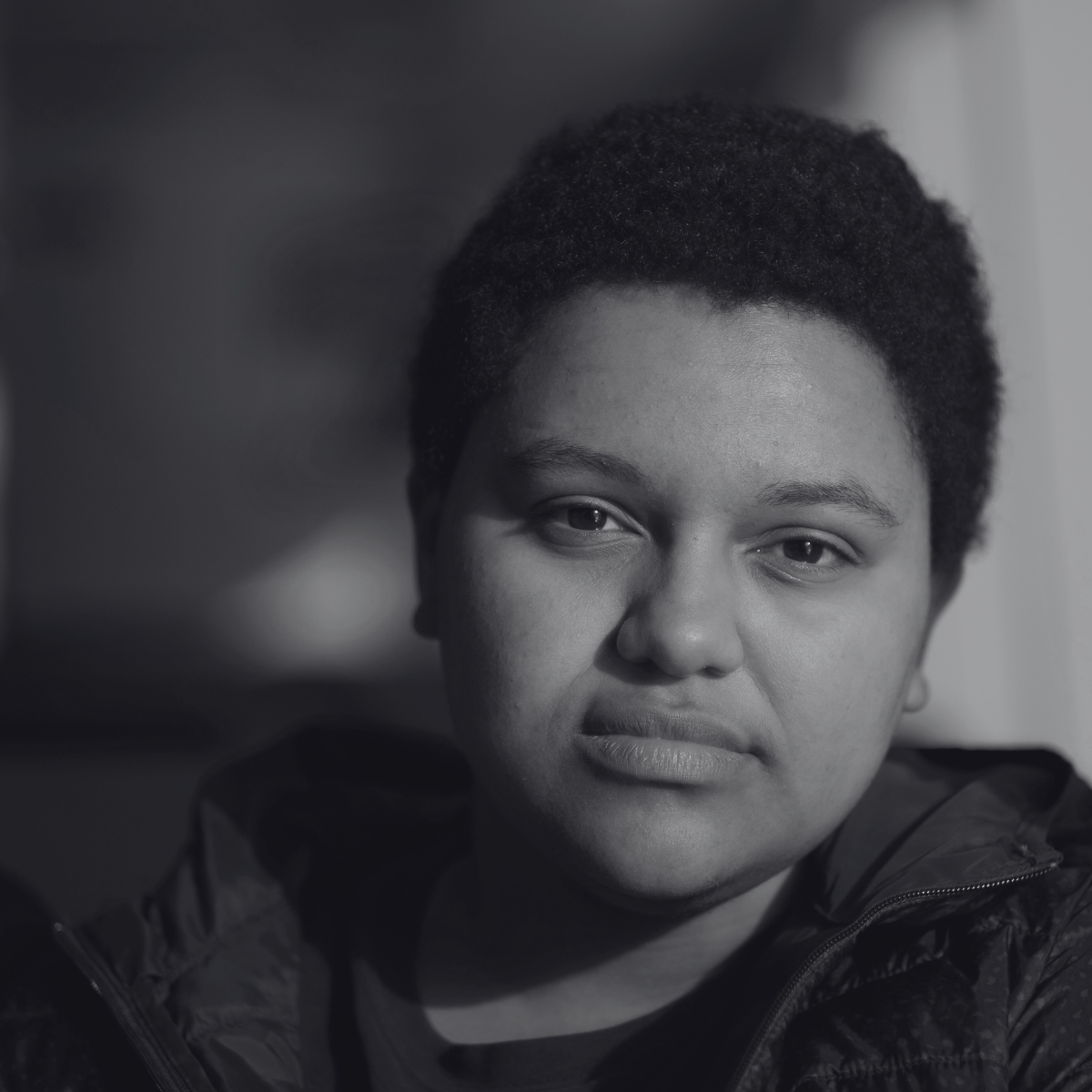 a black and white photo of a person with short dark hair