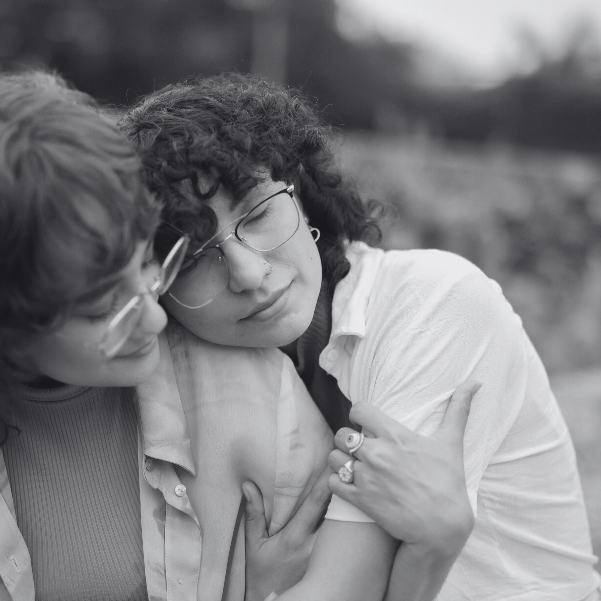 a black and white photo of a couple hugging